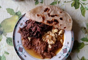 Beef-tongue-and-cheek-barbacoa-re-fried-beans-eggs-with Chile-sauce-and-tortillas.